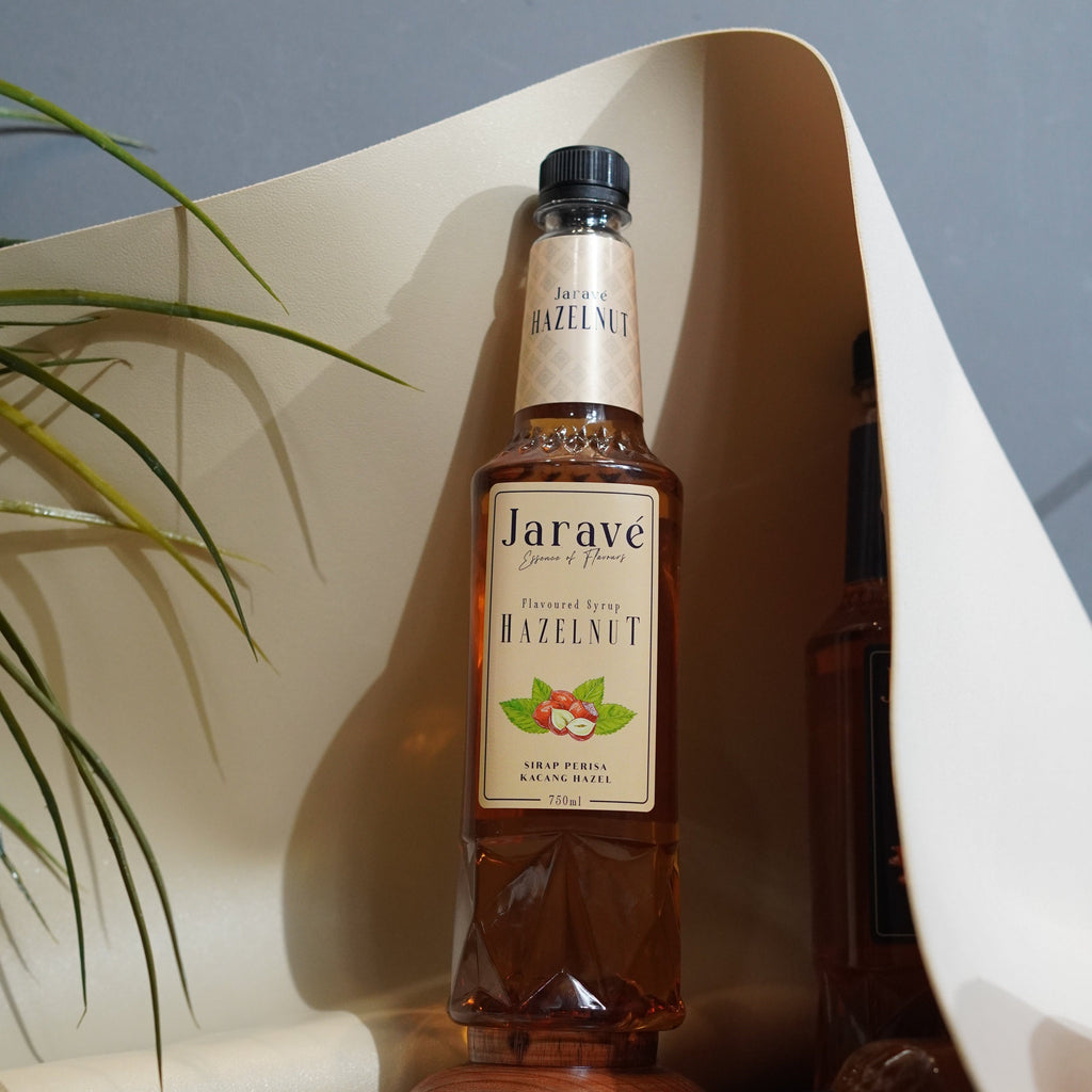 "Bottle of Jarave hazelnut on a reflective surface with a blurred background"
